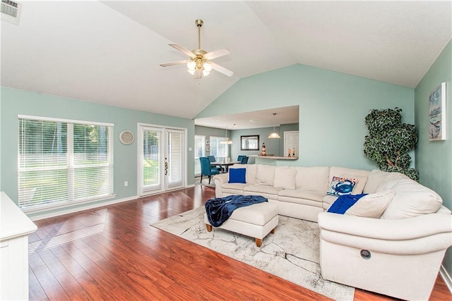 living room featuring a ceiling fan, baseboards, visible vents, and wood finished floors