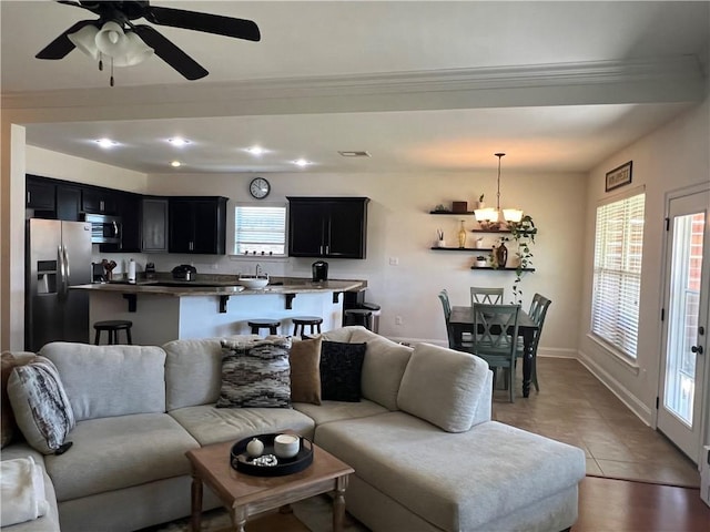 living room featuring light tile patterned floors, plenty of natural light, baseboards, and recessed lighting