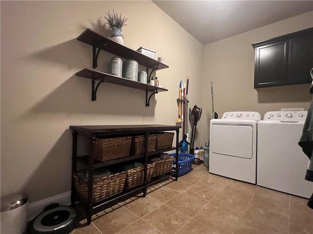 clothes washing area with cabinet space, light tile patterned floors, and washing machine and clothes dryer