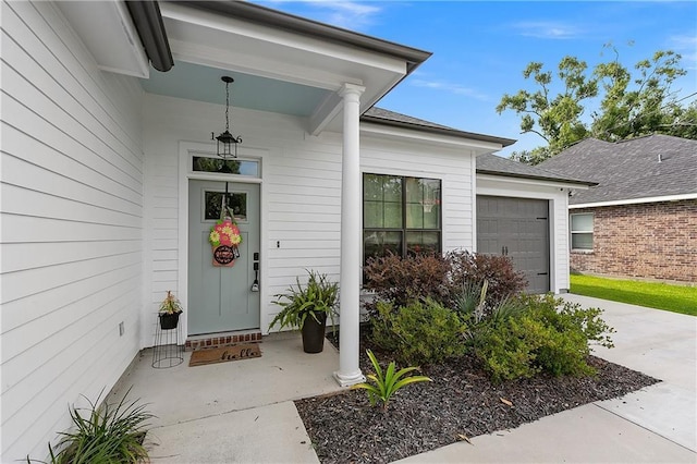 entrance to property featuring a garage and driveway