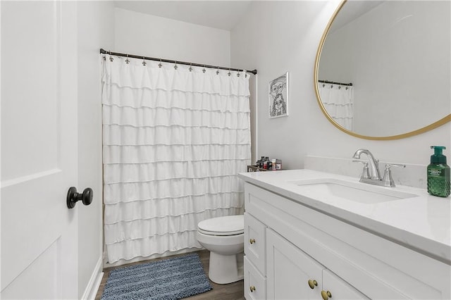 bathroom featuring toilet, wood finished floors, vanity, and a shower with curtain