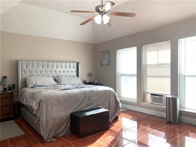 tiled bedroom with lofted ceiling, a textured ceiling, a ceiling fan, and cooling unit