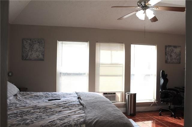 tiled bedroom with cooling unit and ceiling fan