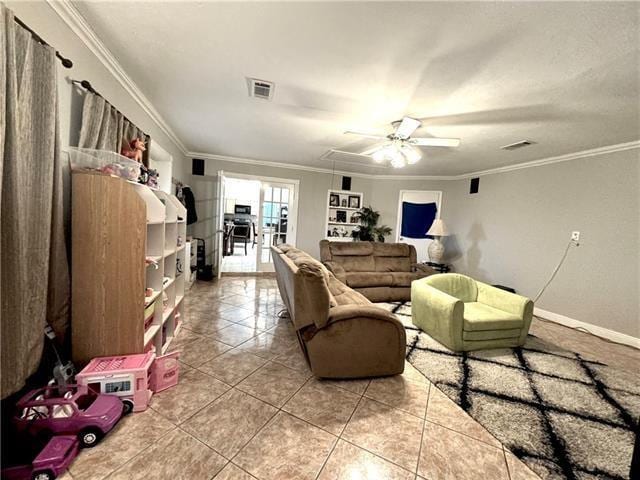 living room featuring ceiling fan, visible vents, crown molding, and light tile patterned floors