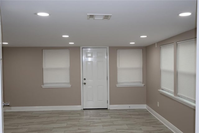 unfurnished room with recessed lighting, visible vents, and baseboards