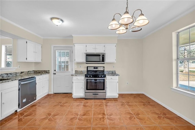 kitchen featuring stainless steel appliances, white cabinetry, and plenty of natural light