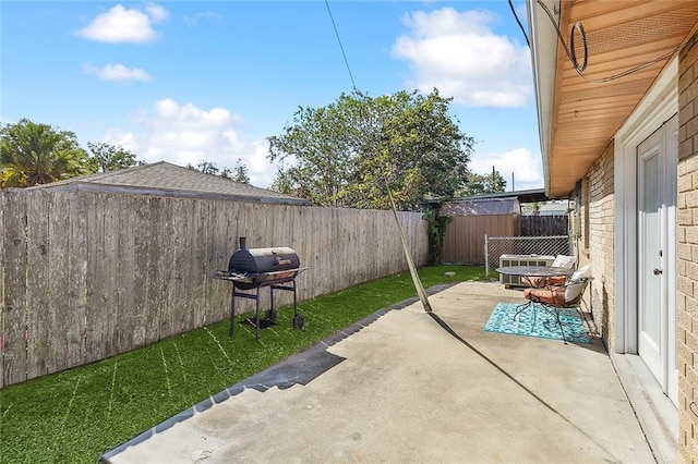 view of patio / terrace with a fenced backyard and area for grilling