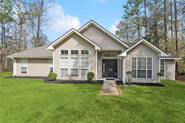 view of front of property with a front lawn and roof with shingles