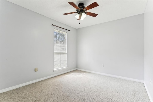 unfurnished room featuring ceiling fan, carpet flooring, and baseboards