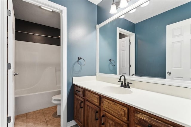 bathroom featuring washtub / shower combination, vanity, toilet, and tile patterned floors