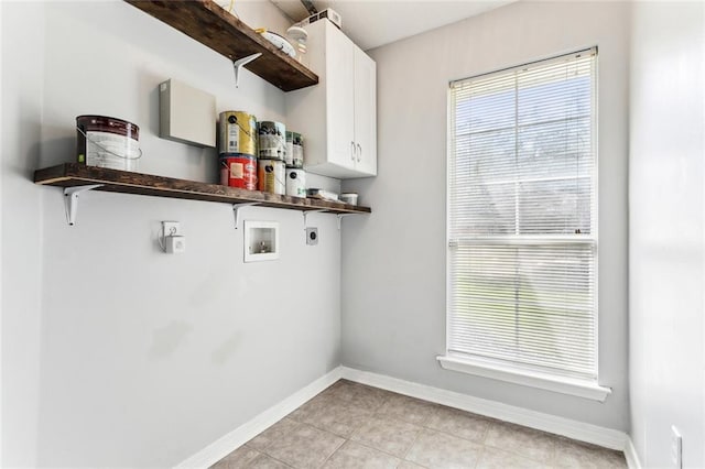 washroom featuring light tile patterned flooring, hookup for a washing machine, baseboards, cabinet space, and electric dryer hookup