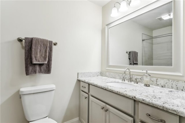 full bathroom with toilet and vanity