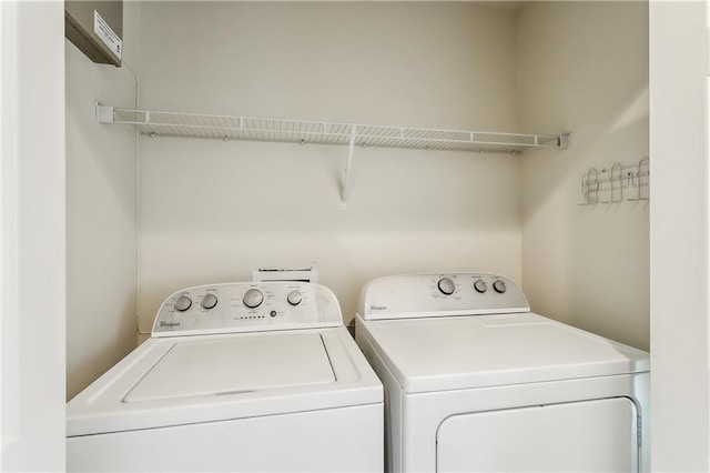 clothes washing area featuring laundry area and washer and clothes dryer