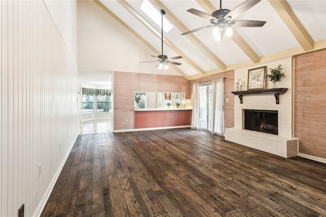 unfurnished living room featuring dark wood-style floors, beam ceiling, a brick fireplace, high vaulted ceiling, and baseboards