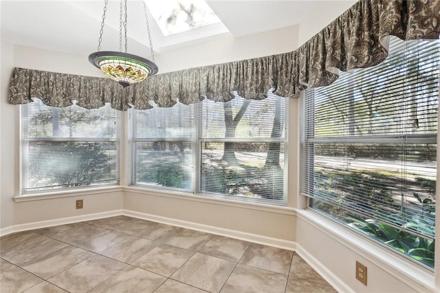 unfurnished dining area featuring a wealth of natural light, baseboards, and tile patterned floors