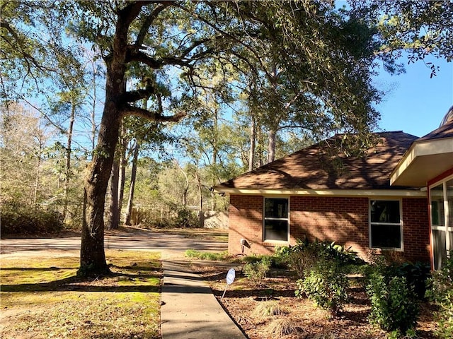 view of side of home featuring brick siding