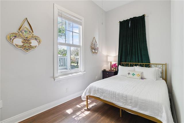 bedroom with baseboards and wood finished floors