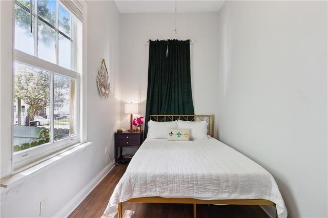 bedroom with dark wood-style flooring and baseboards