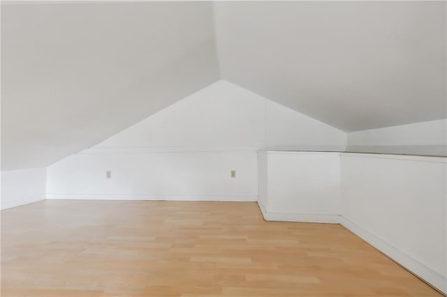 bonus room with vaulted ceiling and wood finished floors