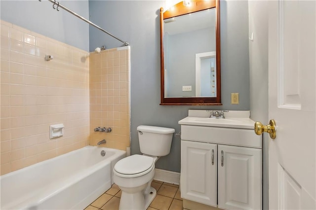 full bath featuring baseboards, toilet, tile patterned flooring, vanity, and washtub / shower combination