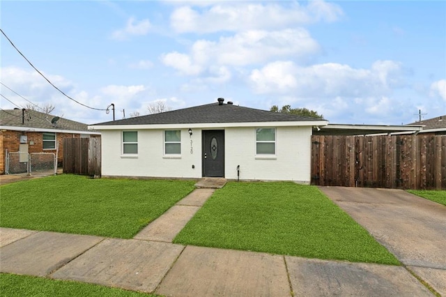 view of front of home featuring brick siding, a front yard, and fence