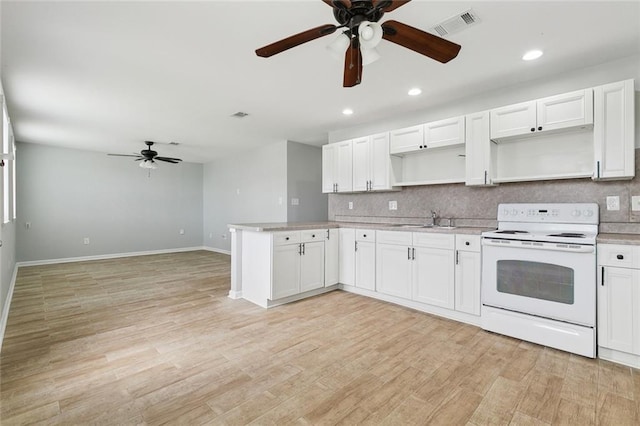 kitchen with white cabinets, electric stove, and light countertops