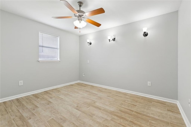 empty room with light wood-type flooring, ceiling fan, and baseboards