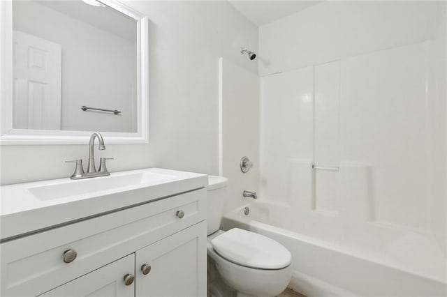 bathroom with bathing tub / shower combination, toilet, and vanity