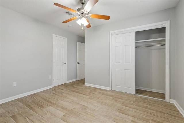 unfurnished bedroom featuring a closet, visible vents, light wood-style flooring, and baseboards