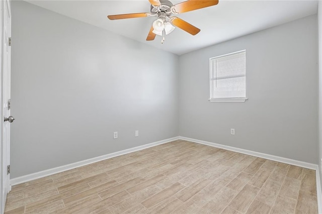 empty room featuring ceiling fan, light wood-style flooring, and baseboards