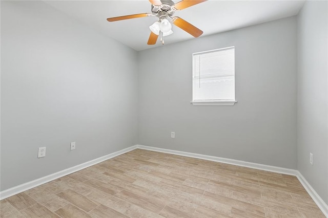 spare room with light wood-style floors, baseboards, and a ceiling fan