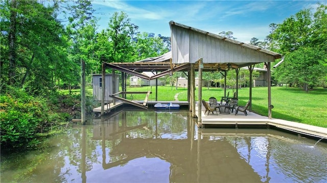 view of dock featuring a yard and a water view