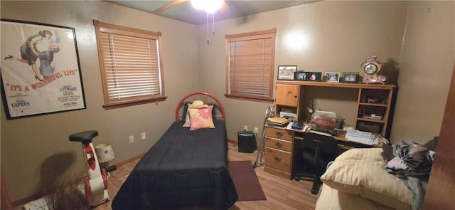 bedroom featuring light wood-type flooring and baseboards