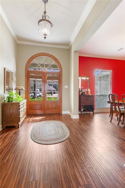 entrance foyer featuring french doors, an inviting chandelier, wood finished floors, and baseboards