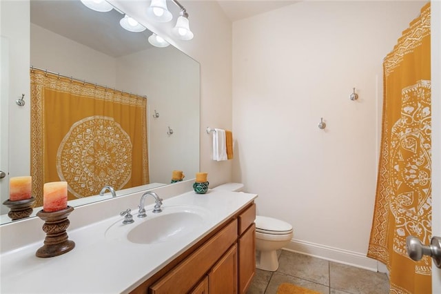 bathroom with toilet, tile patterned floors, baseboards, and vanity