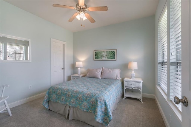 bedroom with ceiling fan, carpet flooring, and baseboards