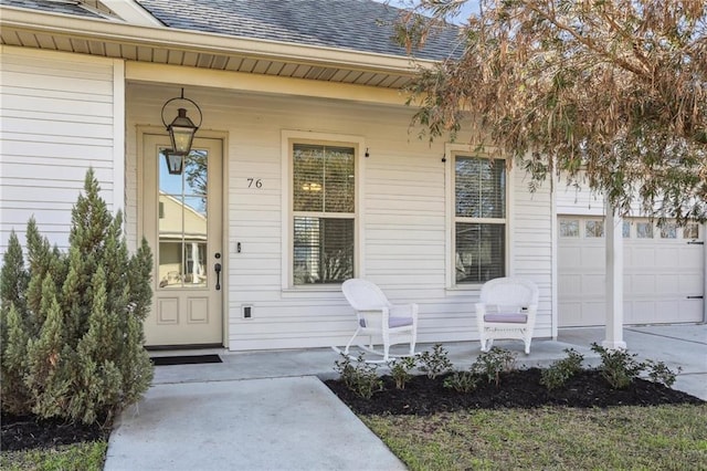 property entrance with a garage, a porch, and roof with shingles