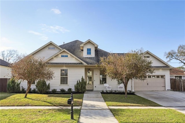 view of front of house with a garage, concrete driveway, a front yard, and fence