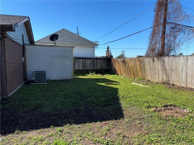 view of yard featuring a fenced backyard and central AC unit