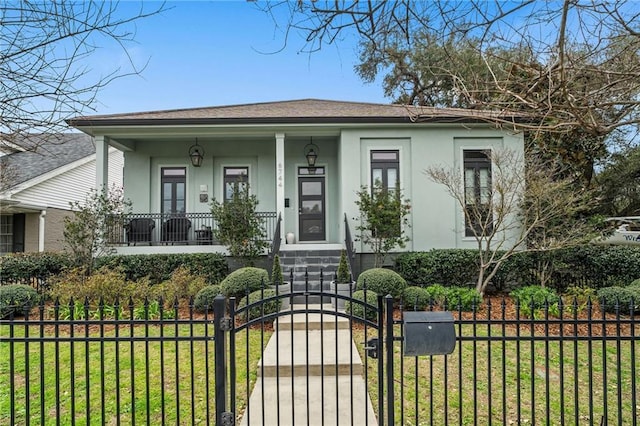 bungalow-style home with a fenced front yard, a gate, a front lawn, and stucco siding