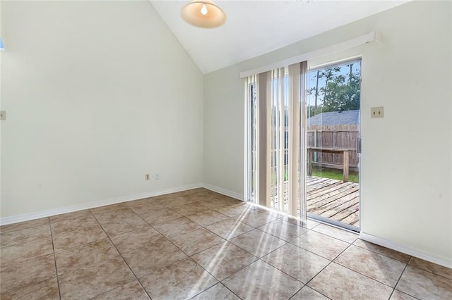 unfurnished room with light tile patterned floors, vaulted ceiling, and baseboards