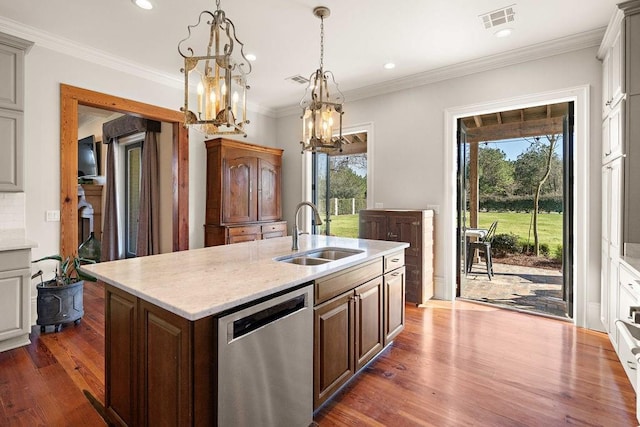 kitchen featuring pendant lighting, visible vents, a sink, an island with sink, and dishwasher