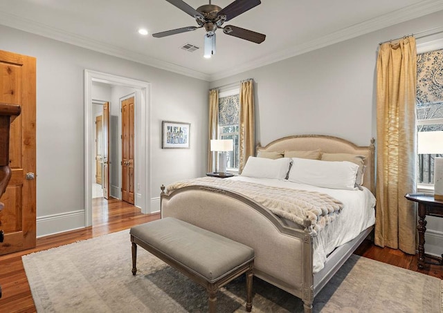 bedroom with baseboards, visible vents, dark wood-style flooring, and ornamental molding