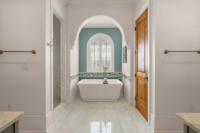 bathroom featuring a tile shower, a freestanding tub, vanity, and crown molding