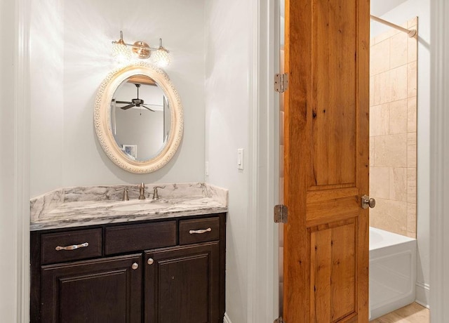 bathroom featuring washtub / shower combination and vanity