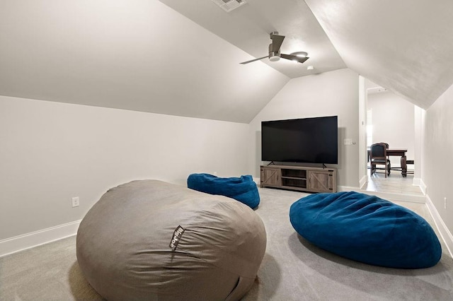 cinema room featuring light carpet, ceiling fan, baseboards, and lofted ceiling