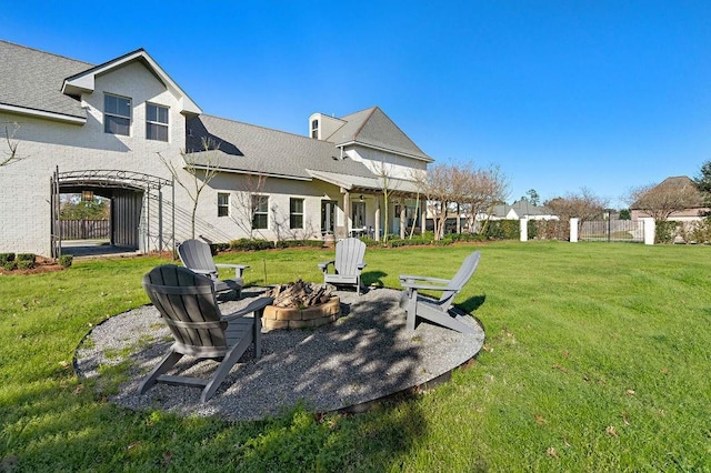 view of yard featuring an outdoor fire pit and fence