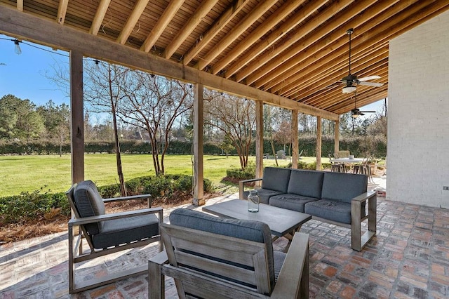 view of patio / terrace featuring ceiling fan, outdoor dining space, and an outdoor living space