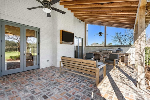 view of patio with outdoor lounge area, area for grilling, a ceiling fan, french doors, and grilling area