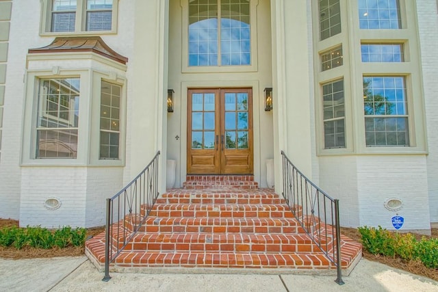 property entrance with french doors and brick siding